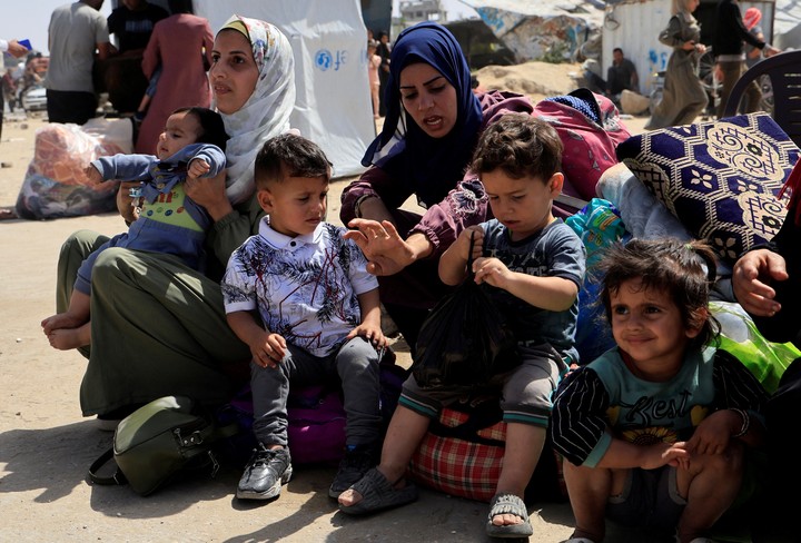 Palestinas huyen con sus hijos de los bombardeos de Israel. Foto: Reuters